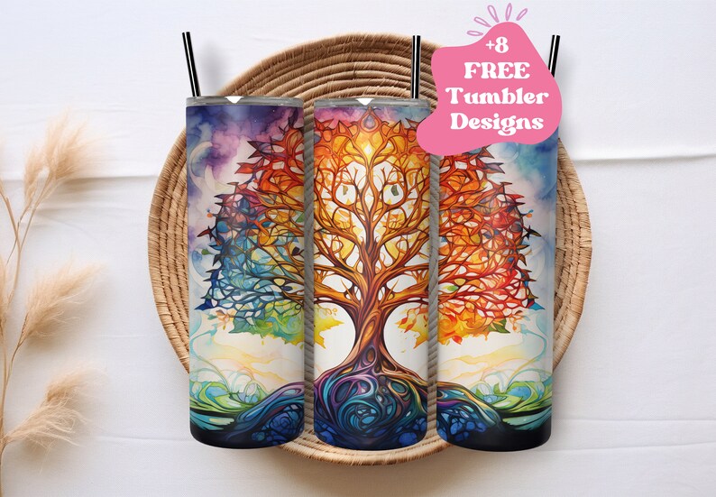 May include: Three stainless steel tumblers with a colorful tree of life design. The tree features a vibrant watercolor style with hues of blue, orange, and purple. Each tumbler has a black straw and is displayed in a woven basket.