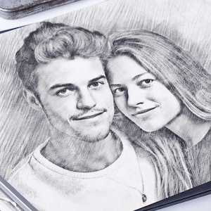 May include: A black and white pencil drawing of a couple. The man is on the left and the woman is on the right. They are both looking at the viewer. The man has short, dark hair and a beard. The woman has long, light hair. They are both smiling.