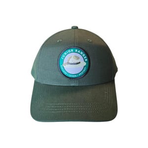 May include: A green baseball cap with a Junior Ranger patch featuring a cartoon ranger hat and the text "Explore - Learn - Protect".