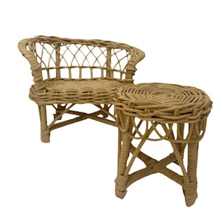 May include: A wicker dollhouse furniture set with a small couch and a matching end table. The furniture is made of woven wicker and has a natural brown color.