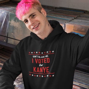 May include: A black hoodie with a red print that says "Don't blame me. I voted for Kanye." with stars above and below the text.