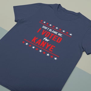 May include: A navy blue t-shirt with a white star pattern and red text that reads "DON'T BLAME ME. I VOTED for KANYE".