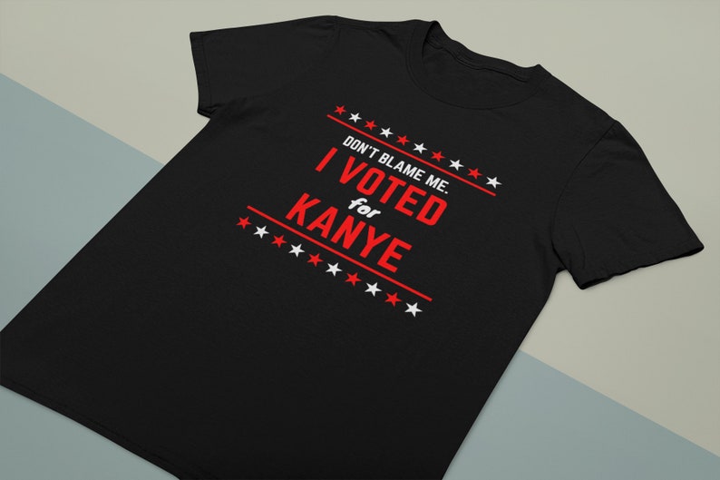 May include: Black t-shirt with white text that reads "Don't blame me. I voted for Kanye" with red stars.