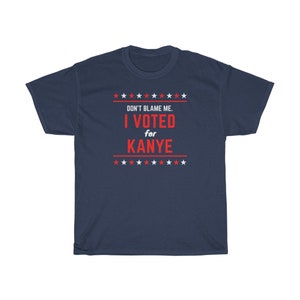 May include: A navy blue t-shirt with a red and white design. The text on the shirt reads "Don't blame me. I voted for Kanye." with stars above and below the text.
