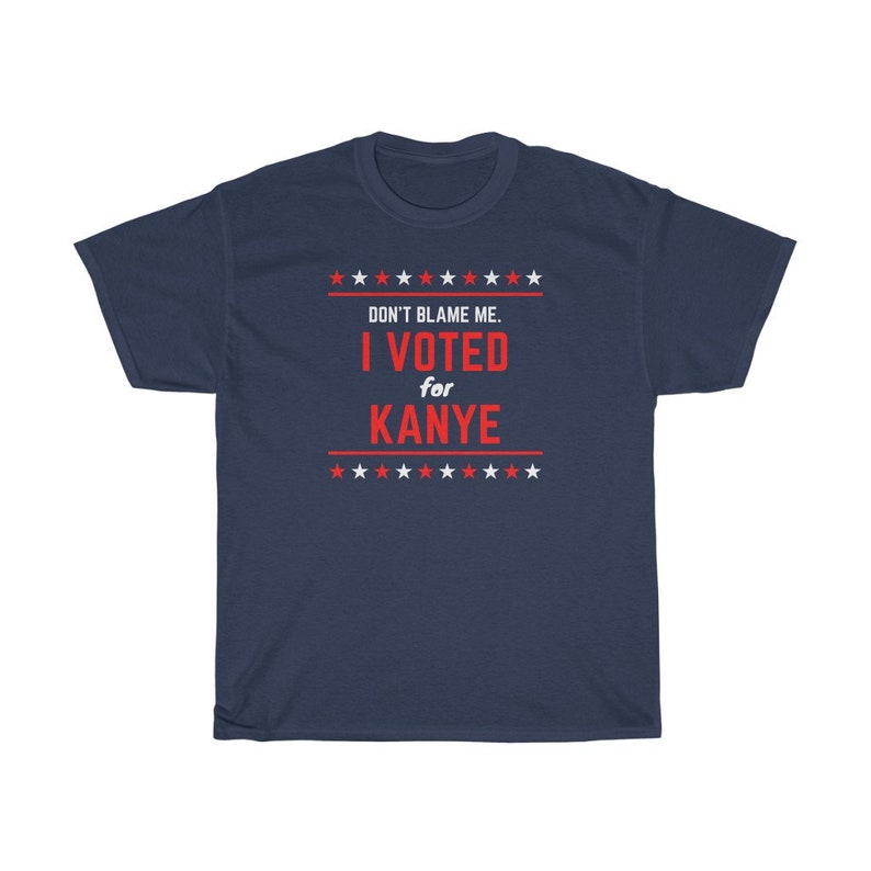 May include: A navy blue t-shirt with a red and white design. The text on the shirt reads "Don't blame me. I voted for Kanye." with stars above and below the text.