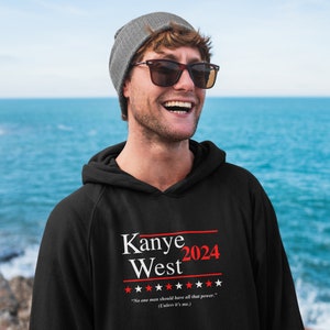 以下が含まれることがあります： 「Kanye West 2024」と星と「誰もがその力をすべて持つべきではない。（私以外。） 」という引用が書かれた白いプリントが施された黒いパーカー