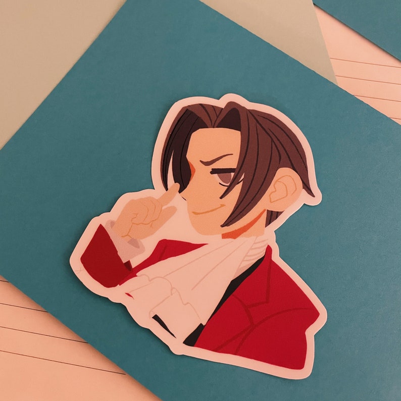 May include: A cartoon sticker of a man with brown hair wearing a red jacket and a white scarf. He is smiling and has his finger to his lips.