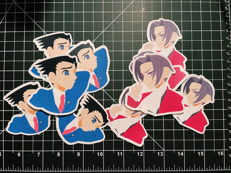 May include: A set of six stickers featuring anime characters. The stickers are printed on white paper with a glossy finish. The characters are depicted in various poses and expressions. The stickers are perfect for adding a touch of personality to laptops, water bottles, or other belongings.