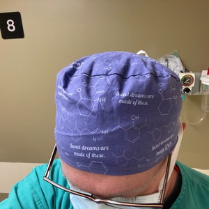 May include: A blue surgical scrub hat with a white print of chemical structures and the text "Sweet dreams are made of these."