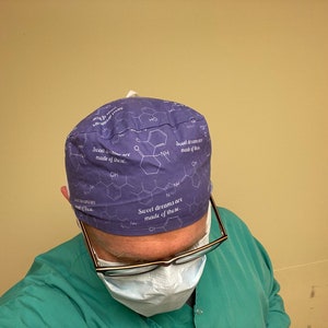 May include: A purple scrub hat with a white chemical structure and the text "Sweet dreams are made of these." printed on it.