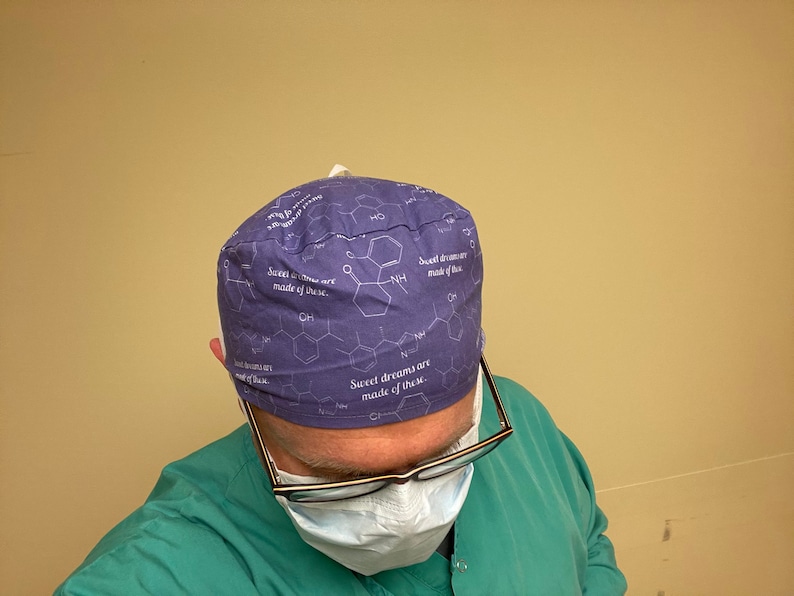 May include: A purple scrub hat with a white chemical structure and the text "Sweet dreams are made of these." printed on it.