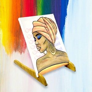 May include: A painting on canvas of a woman with a light brown headscarf and blue eyeshadow. The woman is wearing a large gold hoop earring. The painting is on a wooden easel.
