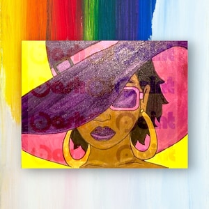 May include: A woman with dark skin is wearing a large, pink and purple hat with a brim that covers her eyes. She is also wearing sunglasses and large gold hoop earrings. The background is a yellow and rainbow striped pattern.