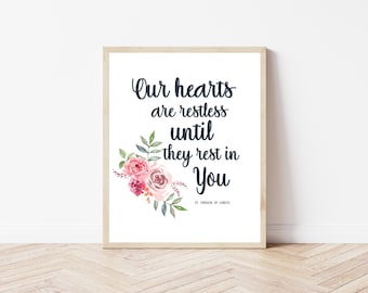 May include: A white printable art print with a floral design and the quote "Our hearts are restless until they rest in You - St. Therese of Lisieux".