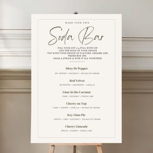 May include: A white sign with black text that reads "Make Your Own Soda Bar". The sign lists different soda combinations with ingredients like Dr. Pepper, coconut, raspberry, vanilla, Coke, cherry, lime, and Sprite.