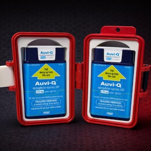 May include: Two red cases, each containing an Auvi-Q epinephrine auto-injector. The blue and white label on each device reads "Auvi-Q epinephrine injection USP 0.3 mg auto-injector" with instructions for allergic emergencies. The cases are open, revealing the devices.