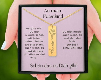 May include: A gold necklace with a pendant that says "Annelise" and has a small flower design. The pendant is in a box with a message that says "An mein Patenkind" and includes a message about being unique and strong.