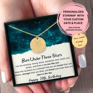 May include: A gold necklace with a round pendant featuring a star map design. The necklace is in a black box with a white card that reads "Born Under These Stars" and "Happy 30th Birthday".