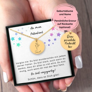 May include: A gold necklace with a round pendant featuring a rose and the name "Sarah" engraved on it. The necklace is in a black box with a white background and stars. The box also has a message that says "An mein Patenkind" and "Vergiss nie: Du bist wunderschön mit jedem deiner Fehler. Du bist stark, auch wenn du denkst, dass dir alles zu viel wird. Du bist mutig, auch wenn dir mal der Mut fehlt. Du bist einzigartig! Schön, dass es Dich gibt!"