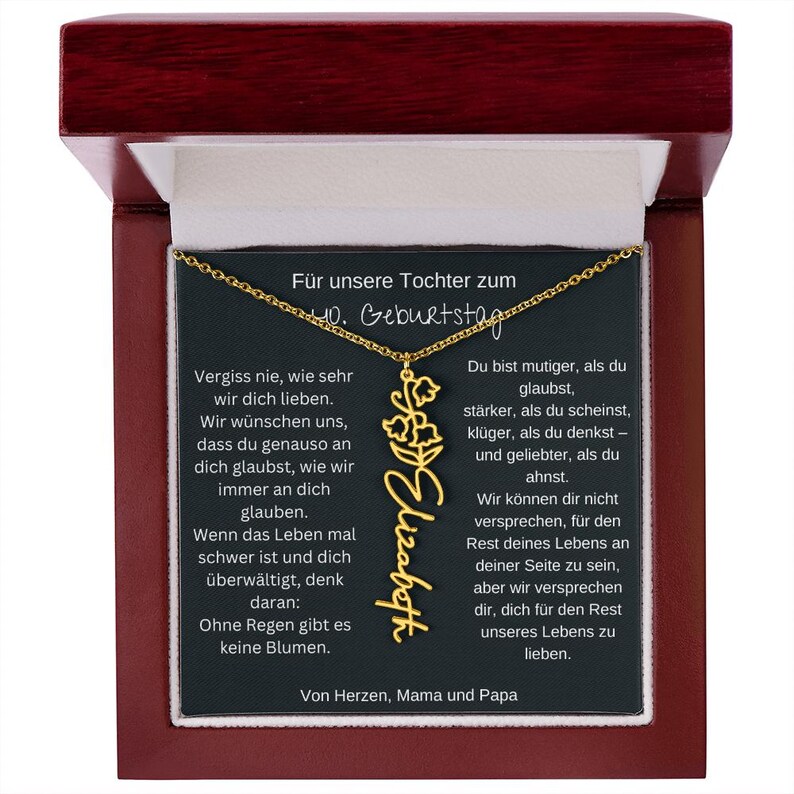 a wooden plaque with a gold necklace on it
