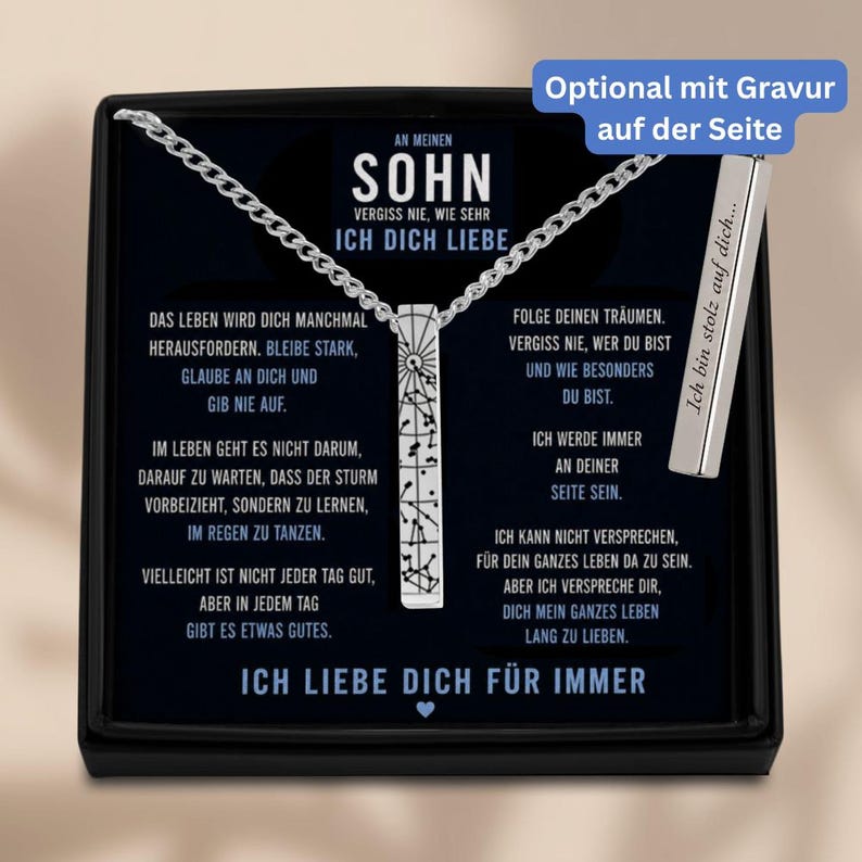 The image is a necklace with a pendant that contains a message in German. The message is in German and is written in a box, which is placed on a black background. The necklace is silver and has a chain attached to it. The message on the necklace reads "An Menen Sohn Vergiss me Wieder Sehr Ich Dich Liebe" and "Ich liebe dich für immer".