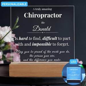 May include: A personalized LED light-up sign with a wooden base. The clear acrylic panel features the text "A truly amazing Chiropractor like Donald...impossible to forget." The sign is designed to be a gift.