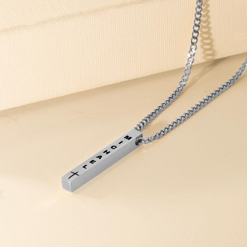 a silver necklace with a cross on it