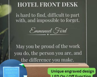 May include: A personalised LED desk sign with the text "HOTEL FRONT DESK" and a message. The sign has a wooden base and a clear acrylic panel with engraved text. The sign is lit with a blue light and has an LED on/off function.