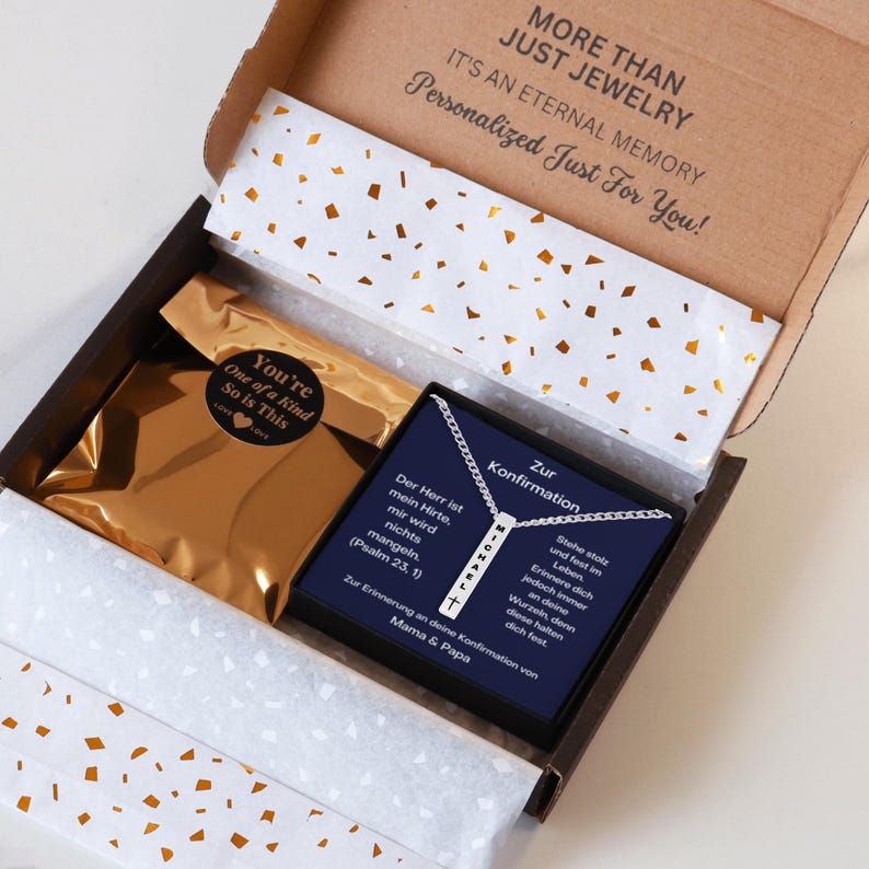 an open box containing a necklace and a card