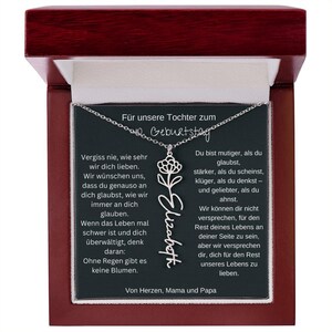 a wooden frame with a necklace hanging from it