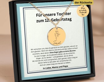 May include: A gold necklace with a round pendant engraved with the name "Sarah" and a floral design. The necklace is in a black box with a message that reads "For our daughter on her 12th birthday".