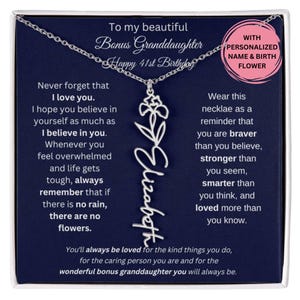 May include: A blue gift box with a silver necklace inside. The necklace has a silver pendant with a flower design and the name "Elizabeth" written in cursive. The box has a message inside that says "To my beautiful Bonus Granddaughter Happy 41st Birthday" and "Never forget that I love you. I hope you believe in yourself as much as I believe in you. Whenever you feel overwhelmed and life gets tough, always remember that if there is no rain, there are no flowers. You'll always be loved for the kind things you do, for the caring person you are and for the wonderful bonus granddaughter you will always be."