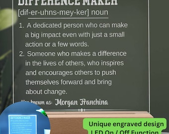 May include: Personalized wooden plaque with a white inscription that reads "Difference Maker" and defines the word as "a dedicated person who can make a big impact even with just a small action or a few words." The plaque has a built-in LED light that can be turned on or off.