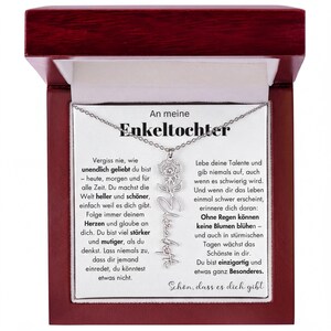 An meine Enkeltochter necklace with a silver pendant featuring a flower design.