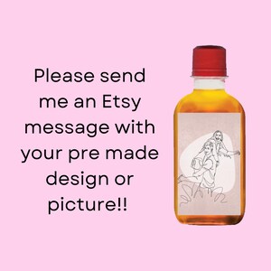 May include: A clear glass bottle with a red cap filled with a light brown liquid. The bottle has a white label with a line drawing of a couple on it. The text "Please send me an Etsy message with your pre made design or picture!" is written below the bottle.