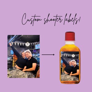 May include: A custom label for a liquor bottle featuring a photo of two people in a bar setting. The label has a white background with a banner of white flags and a disco ball in the background. The text "UTT" is visible on the label.