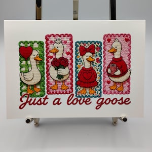 May include: A greeting card featuring four cartoon geese in rectangular frames. Each goose is dressed differently, holding a heart, flowers, wearing a bow, and holding a mug. The text "Just a love goose" is written in cursive below the geese.