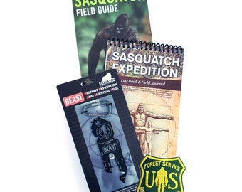 May include: A set of Sasquatch-themed items including a field guide, a journal, a multi-tool keychain, and a patch. The field guide features a drawing of a Sasquatch on the cover. The journal has the text "Sasquatch Expedition Log Book & Field Journal" on the cover. The multi-tool keychain is black and has the text "Beast" on it. The patch is green and has the text "Forest Service US Department of Sasquatch" on it.