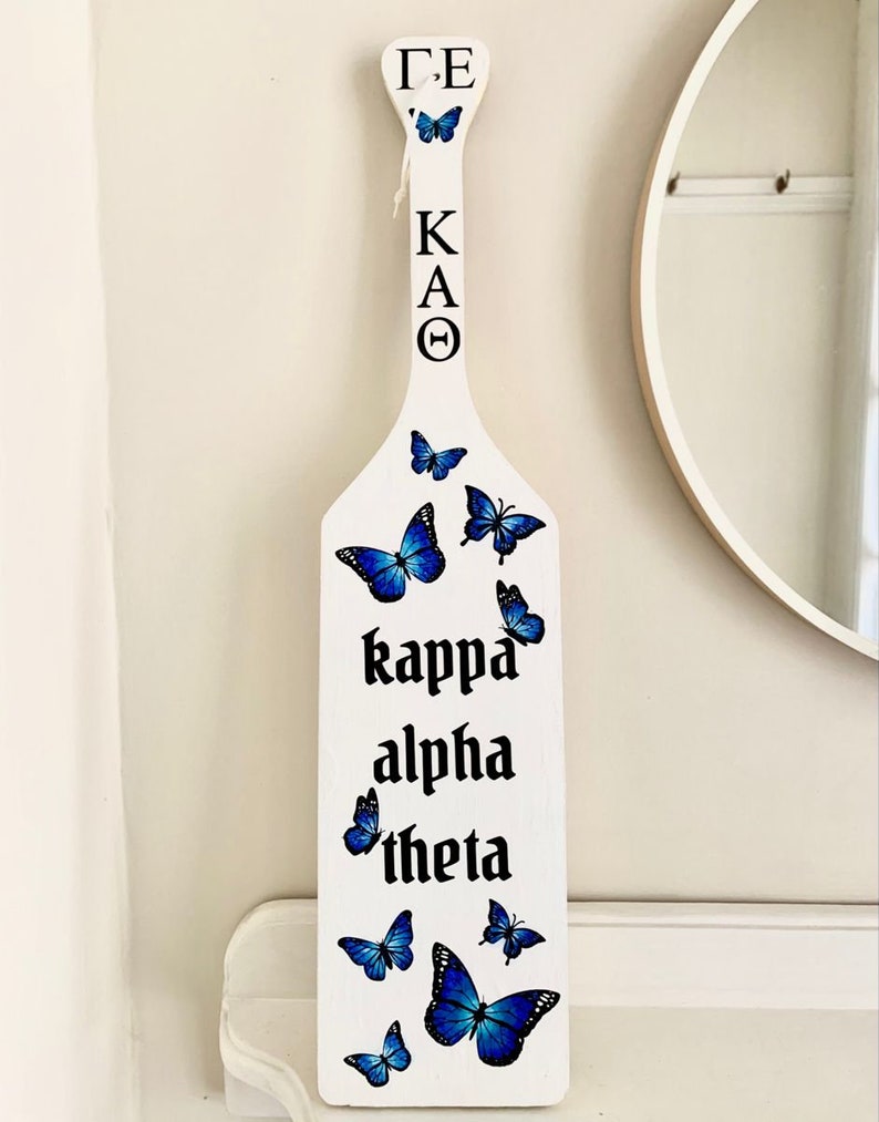 Paddle sticker mockups with the decorated paddle with blue butterflies.