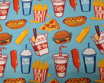 May include: A light blue fabric featuring a repeating pattern of fast food items. The design includes burgers, hot dogs, pizza slices, fries, milkshakes, cola cups, and Chinese takeout boxes. Red and yellow accents are used throughout the design.