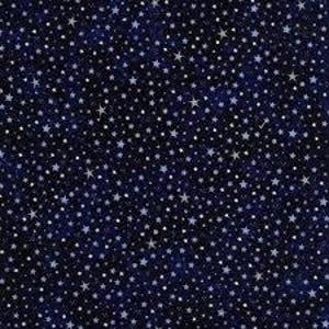 May include: Dark blue fabric featuring a repeating pattern of silver and white stars of various sizes. The stars are dispersed across the material, producing a night sky effect. The fabric looks to be cotton or a similar textile.