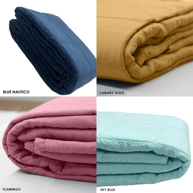 May include: Four folded quilts in different colours: blue, gold, pink, and light blue. The quilts are made of a soft, textured fabric and have a quilted design.
