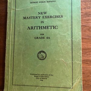 May include: Green cover of a book titled "New Mastery Exercises in Arithmetic for Grade 4A". The book was published by the Board of Education, City of Detroit in 1946.