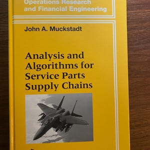 May include: A yellow hardcover book titled Analysis and Algorithms for Service Parts Supply Chains by John A. Muckstadt, part of the Springer Series in Operations Research and Financial Engineering, featuring a black and white image of a fighter jet.