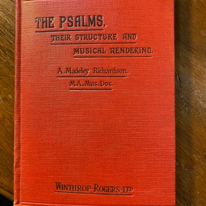 May include: A red book titled "The Psalms. Their Structure and Musical Rendering." by A. Madeley Richardson, M.A. Mus. Doc. The book is published by Winthrop-Rogers-LTP.
