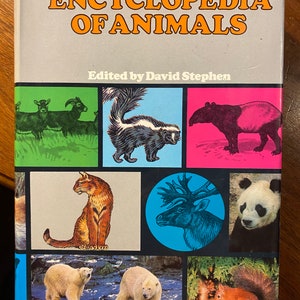 May include: A book titled "Encyclopedia of Animals" edited by David Stephen. The cover features illustrations of various animals, including a skunk, a tapir, a cat, a reindeer, a panda, a polar bear, and a squirrel.