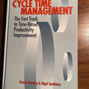 May include: A book titled "Cycle Time Management: The Fast Track to Time-Based Productivity Improvement" by Patrick Northey & Nigel Southway. The cover features a gray and white abstract design.