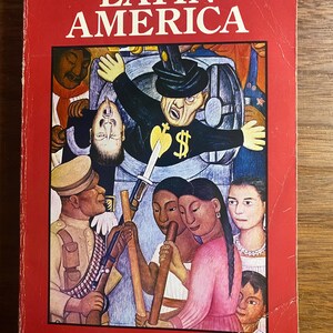 May include: A History of Latin America book by George Pendle. The cover features a vibrant illustration with figures, including a man in a top hat with dollar signs, and various people. The book has a red cover with white text.
