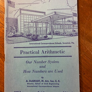 May include: A blue and white cover of a book titled "Practical Arithmetic: Our Number System and How Numbers are Used". The book is by A. DeGroot, M. Am. Soc. C. E., Director, School of Civil Engineering, International Correspondence Schools. The cover features a black and white illustration of a building with a large window and a canopy.