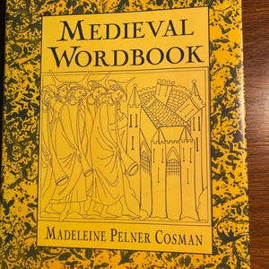 May include: A yellow book with a black and white illustration of people walking towards a castle. The title of the book is "Medieval Wordbook" and the author is "Madeleine Pelner Cosman".